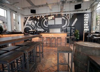 View of the Magic Rock bar showing long tables and industrial feel