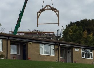 The two storey oak frame being craned in